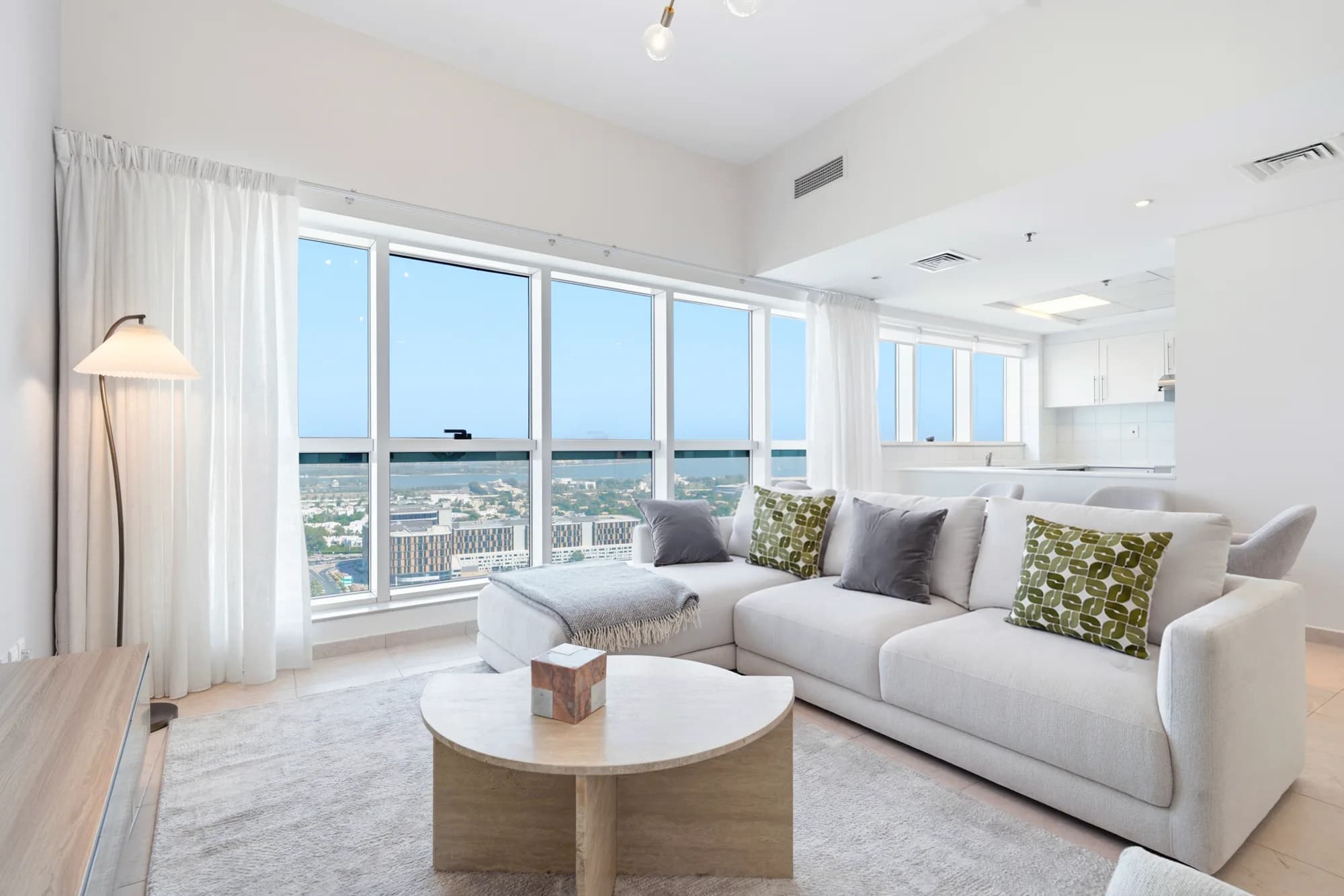 Open-plan living room with floor-to-ceiling windows in a Dubai Jewel Tower residence